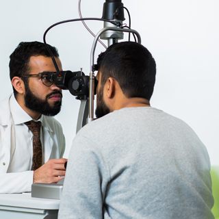 An optician giving a male patient an eye test