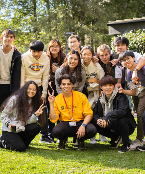 A group of international students at a welcome BBQ outside on campus. 