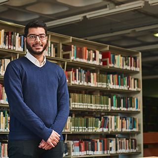 An image of Ahmed Malik in the library