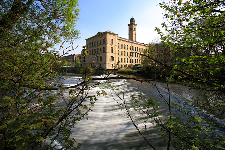 Salts Mill exterior with a river in the foreground