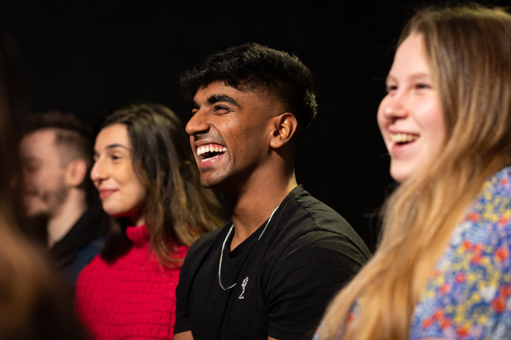 Group of students laughing at a comedy show