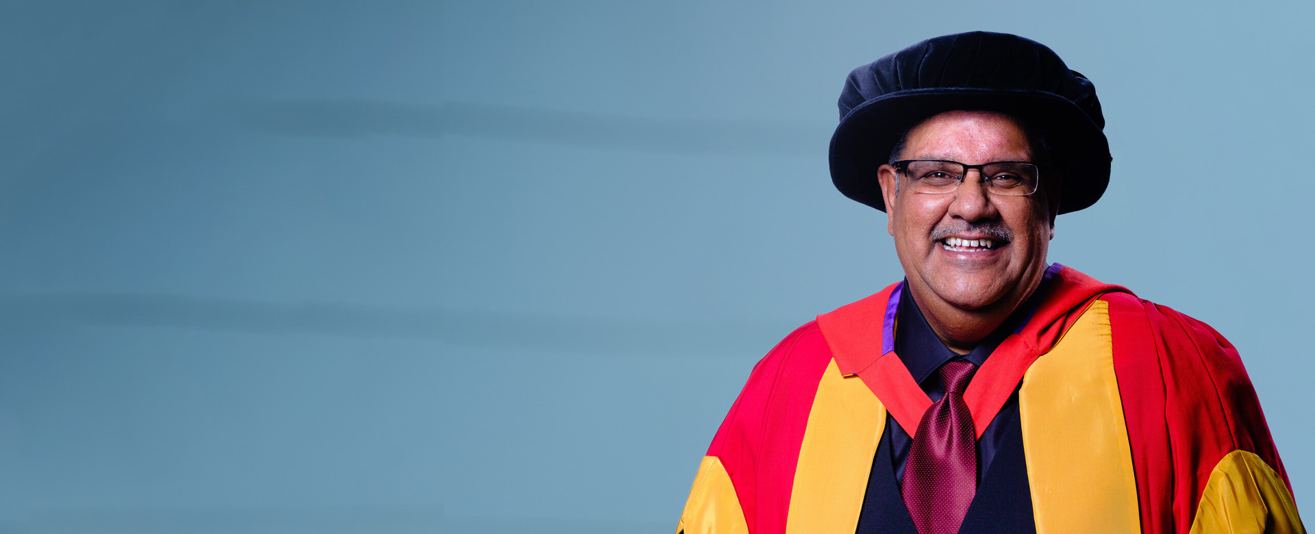 Dr Venkata Satyanarayana Murthy Renduchintala in his honorary graduate robes and hat.