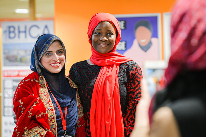 Two students smiling and posing for a photograph at the One World Week Festival 2022.