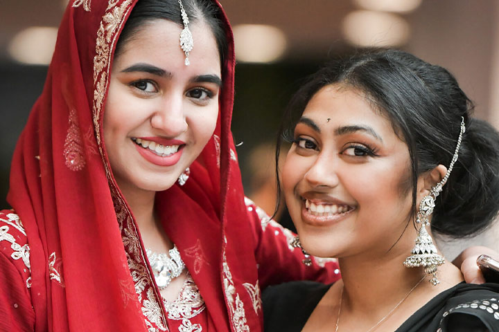 Two students dressed in cultural attire.