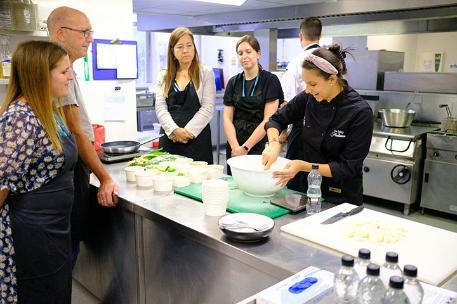 Students attending cooking classes in chef skills academy