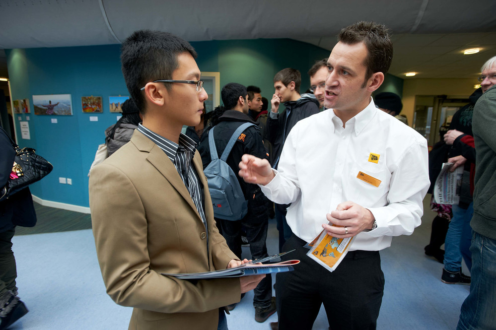 A student chatting to an employer at a Careers Fair