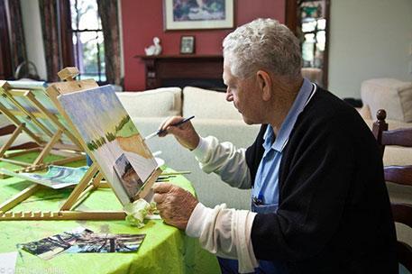 An image of a dementia patient doing a painting.