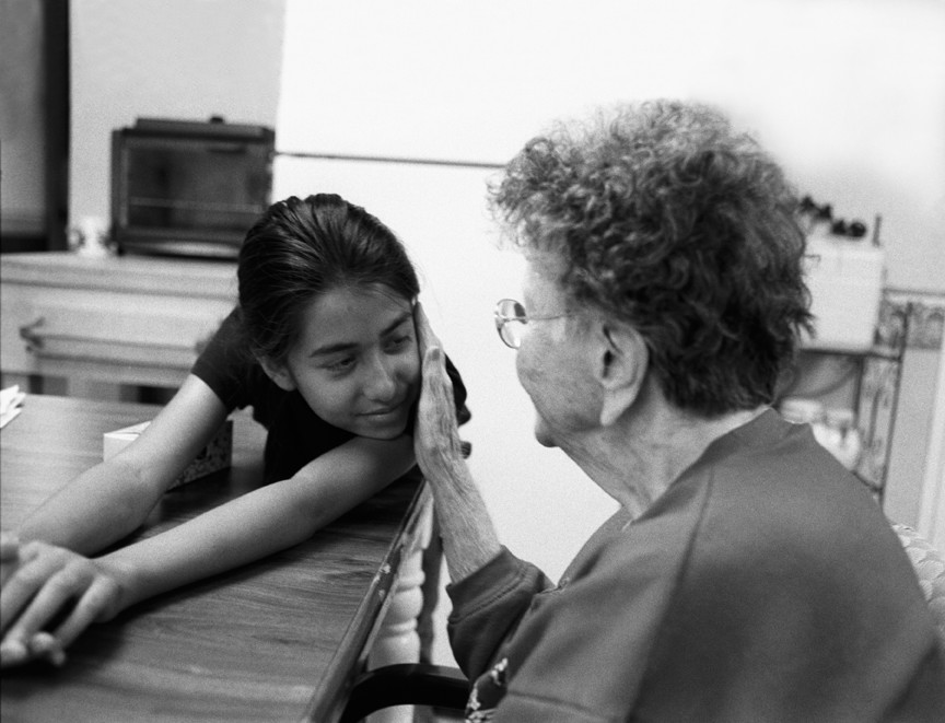 An elderly person with a young girl.