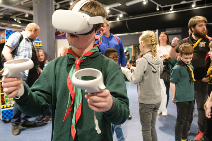 A young boy wearing a virtual reality headset