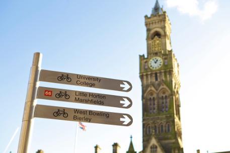 Bradford City Hall Tower with signpost pointing to the University and other city venues