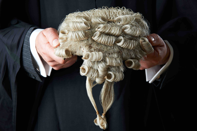 Hands of barrister holding wig