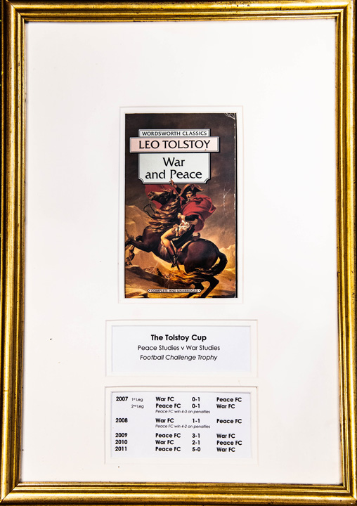 Framed book cover of Leo Tolstoy's War and Peace and game stats from 2007-2011.