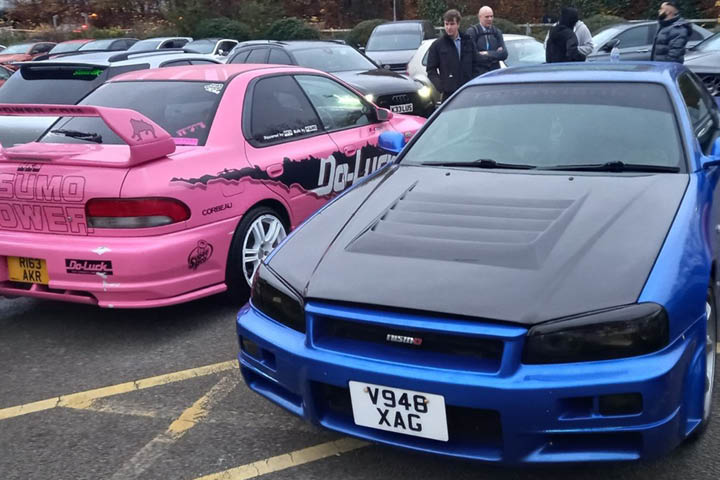 A pink and a blue sports car.