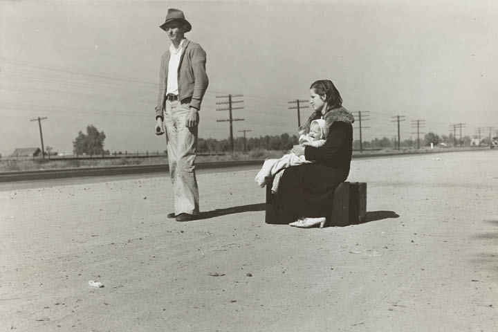 Couple with baby hitchhiking on U.S. Highway 99, California in 1935.