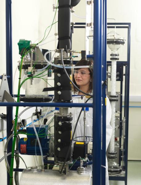 Female student working on equipment in a lab