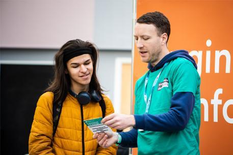 A prospective student discusses the University with a staff member on an Open Day.