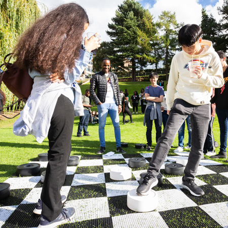 Students playing giant checkers.