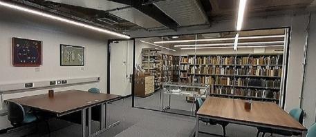 Special Collections Reading Room containing desks, chairs, shelves of books and other reading materials