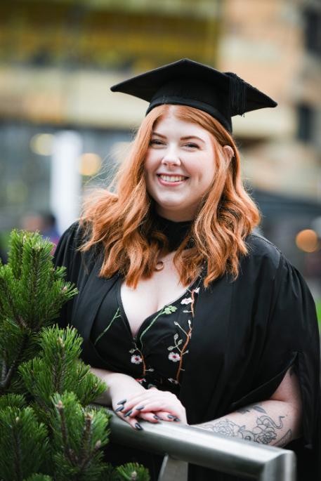 A student in graduation robes
