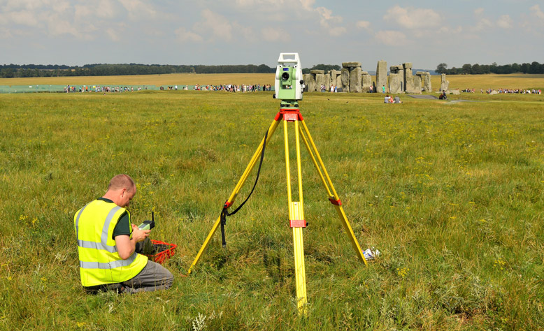 Person surveying Stonehenge with a theodolite.