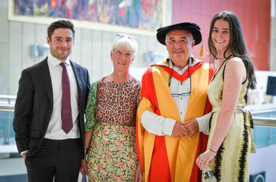 Andrew Dixon with his wife and two children receiving his honorary doctorate