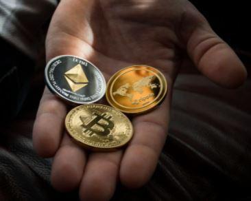 Someone holding a selection of cryptocurrency tokens
