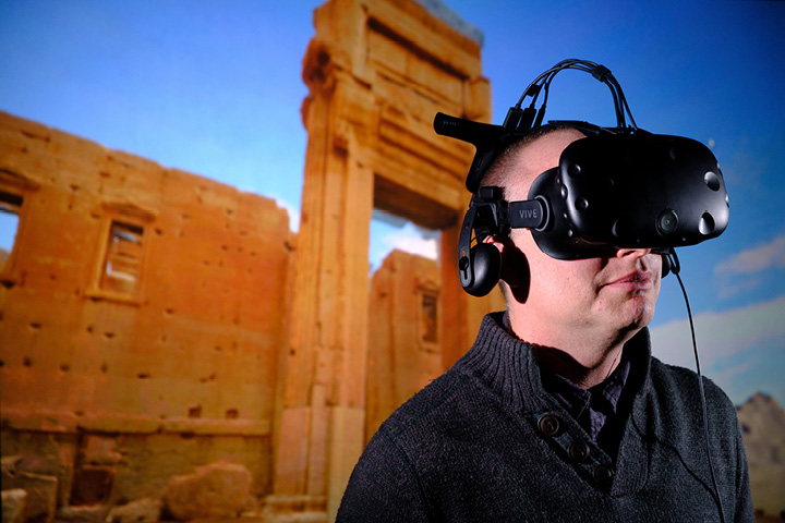 Member of staff using VR to visualise the virtually reconstructed Temple of Bel, Palmyra, Syria