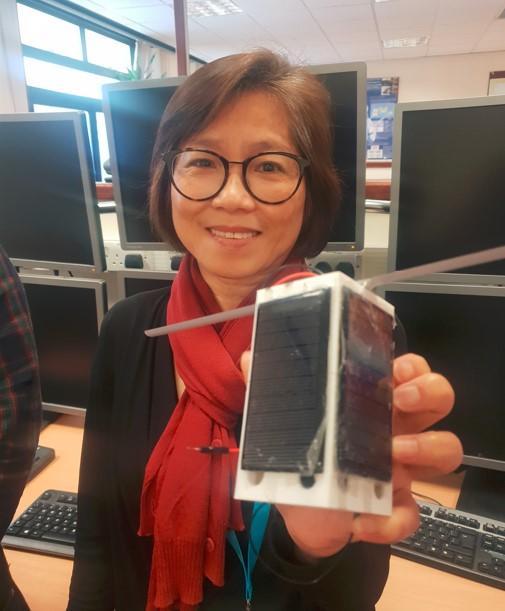 Prof Fun Hu holding the pocket cube model satellite