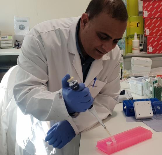 Muhammad Shahid with test tubes in the lab