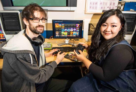 Two students sat down playing video games