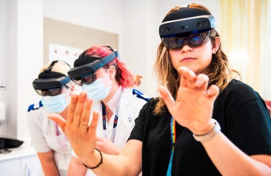 Student midwives wearing augmented reality goggles