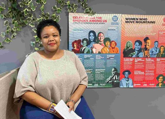 Student sat down in front of Black History Month posters