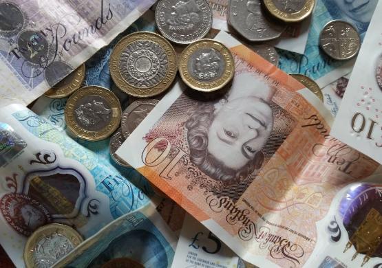 UK paper money and coins spread out