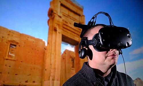 Member of staff wearing visualisation headset to look at buildings of the past