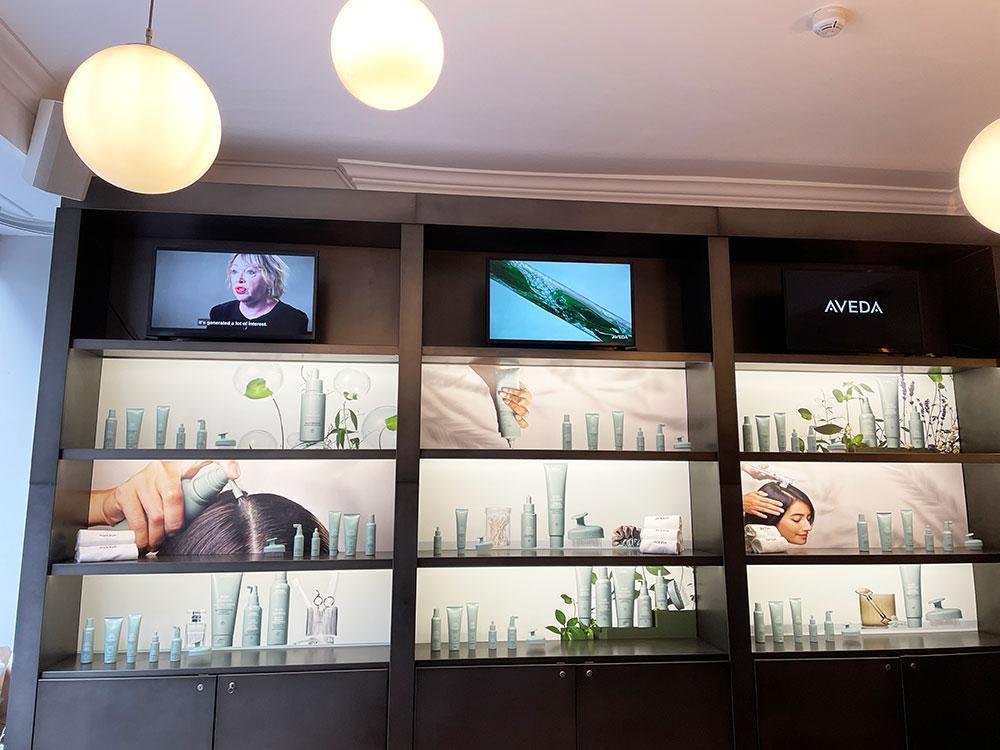 A display of Aveda products with a video of Prof Julie Thornton