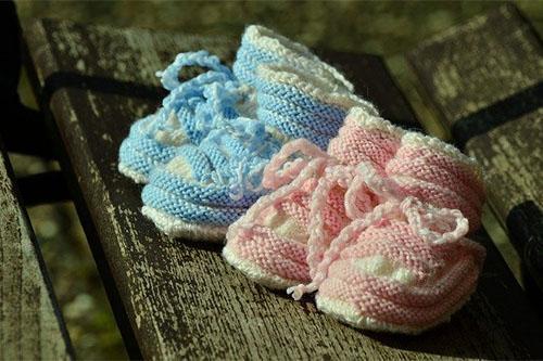 Pair of pink and blue knitted baby shoes 