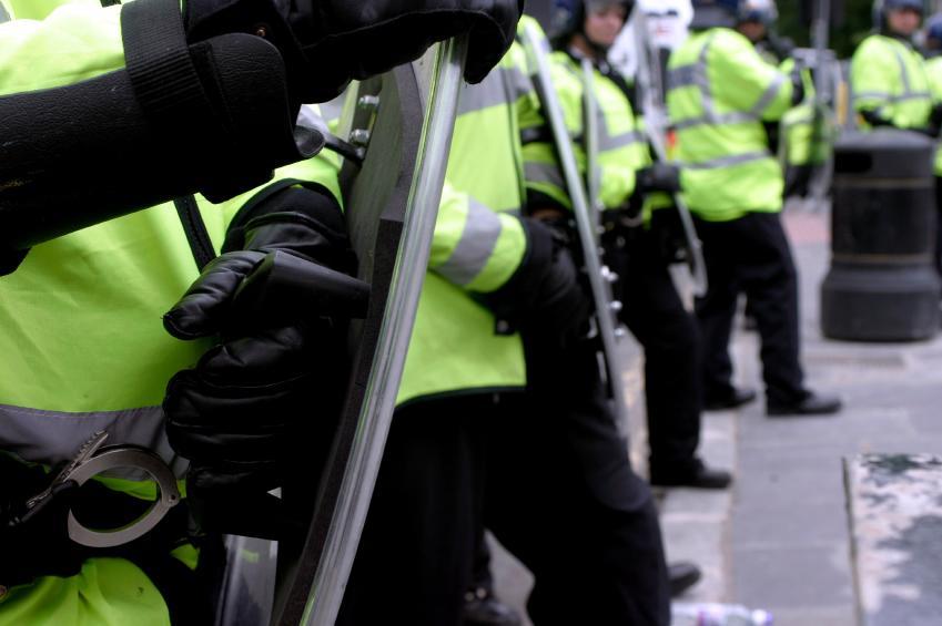 row of police with protective shields
