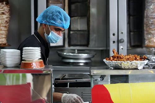 Zero hours contract worker in a kitchen preparing food