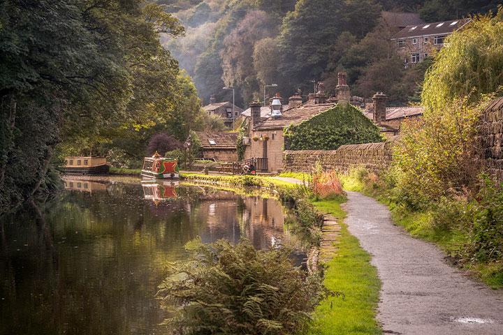 A barge floating on a canal in Hebden Bridge.