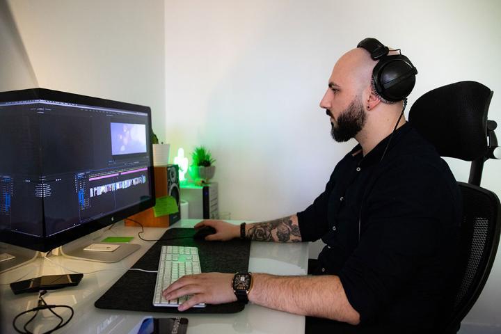 Jordan Dinchev, MA Digital Filmmaking sat at his desk at work.