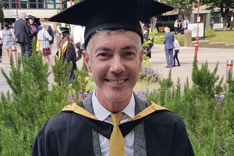 David Bromley, Midwifery MSc graduate summer 2019 in graduation attire