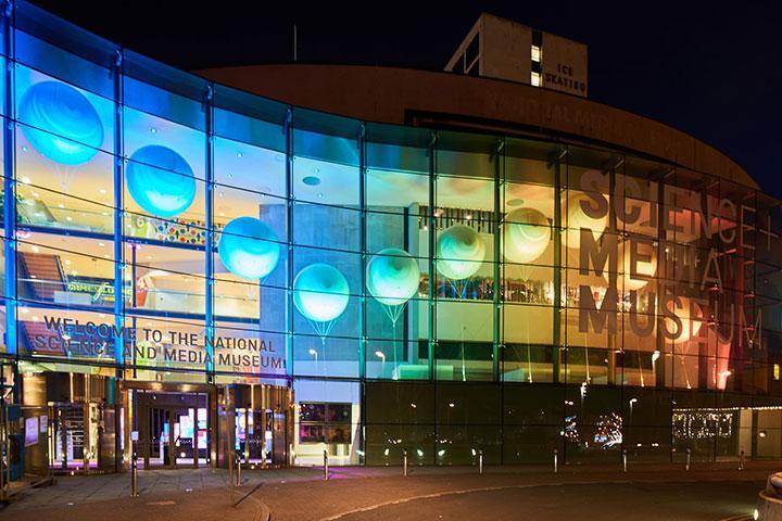 External view of the National Science and Media Museum, lit up at night.