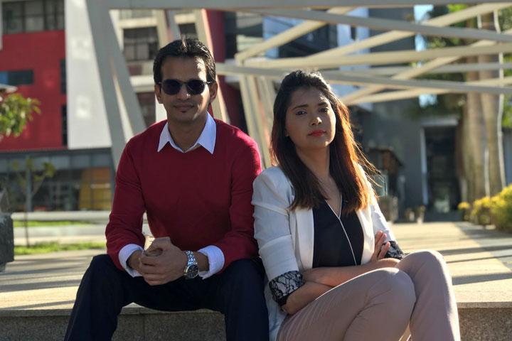 MBA students Shabeel and Farzanah Maudarbaccus sitting together outside