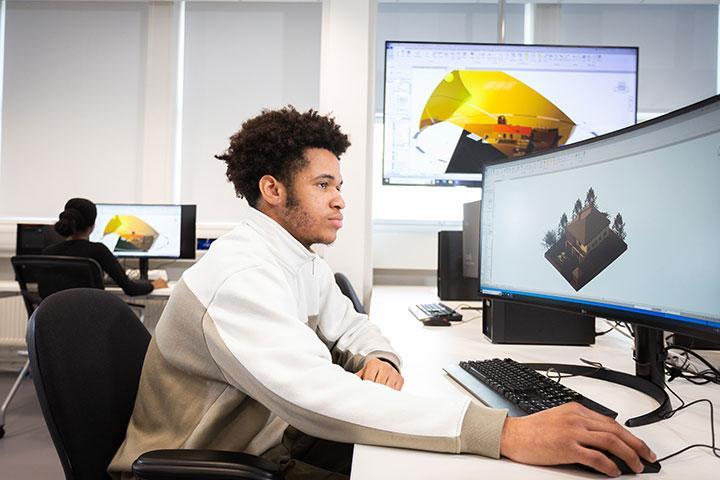 A student creating a 3D model on a computer.