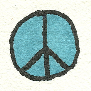 Peace symbol in blue drawn on white stone.