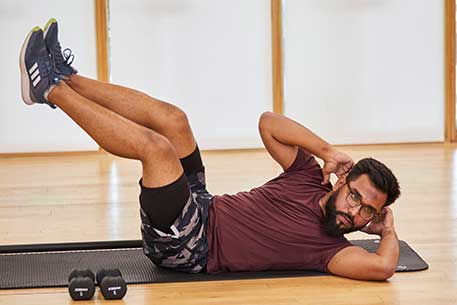 Man doing stomach crunches on mat