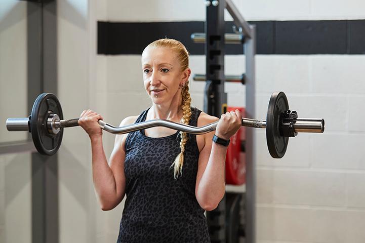 Shelley Hurst lifting weights at the gym