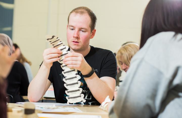 A male Occupational Therapy student in a workshop.