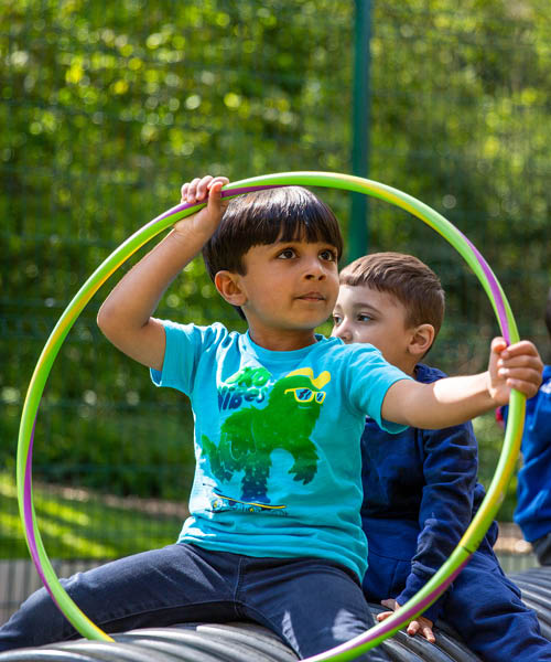 Child playing with hoop