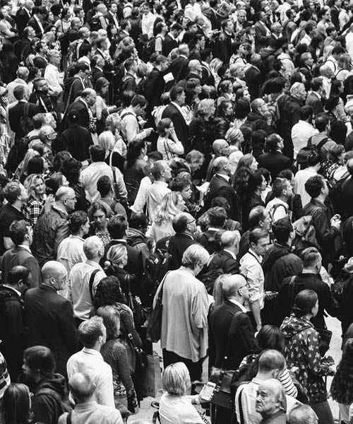 A black and white image of a crowd of people at a public event.